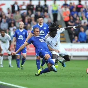Intense Battle for Ball: Jagielka, Browning vs. Gomis - Everton vs. Swansea Premier League Clash Intense Battle for Ball: Jagielka, Browning vs. Gomis - Everton vs. Swansea Premier League Clash