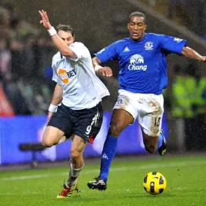 Intense Battle for Ball Possession: Distin vs Elmander, Everton vs Bolton Wanderers, Barclays Premier League (2011) Intense Battle for Ball Possession: Distin vs Elmander, Everton vs Bolton Wanderers, Barclays Premier League (2011)