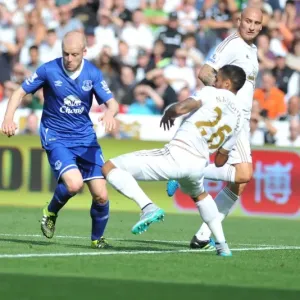Intense Battle for Ball Possession: Naismith vs. Naughton - Swansea City vs. Everton, Premier League Intense Battle for Ball Possession: Naismith vs. Naughton - Swansea City vs. Everton, Premier League