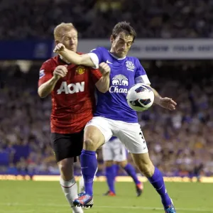 Intense Battle for Ball Possession: Scholes vs. Baines at Goodison Park (Everton 1 - Manchester United 0, Barclays Premier League, 2012) Intense Battle for Ball Possession: Scholes vs. Baines at Goodison Park (Everton 1 - Manchester United 0, Barclays Premier League, 2012)
