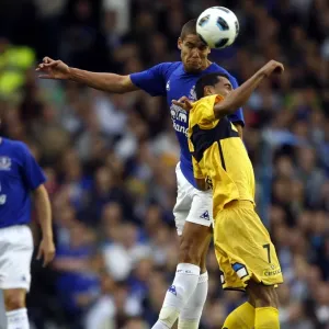 Intense Battle for the Ball: Rodwell vs. Heitinga at Everton Intense Battle for the Ball: Rodwell vs. Heitinga at Everton