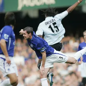 David Weir vs. Didier Drogba Print - Intense Football Field Confrontation David Weir vs. Didier Drogba Print - Intense Football Field Confrontation