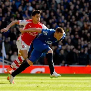Intense Clash: Sanchez Tackles McCarthy in Arsenal vs. Everton (Barclays Premier League)