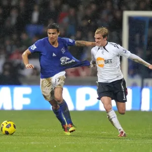 Intense Rivalry: Cahill vs. Holden's Battle for Ball Possession - Everton vs. Bolton Wanderers, Barclays Premier League (2011) Intense Rivalry: Cahill vs. Holden's Battle for Ball Possession - Everton vs. Bolton Wanderers, Barclays Premier League (2011)