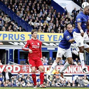Intense Rivalry: Distin vs. Kyrgiakos Aerial Battle in the Everton vs. Liverpool Premier League Clash (October 2010)