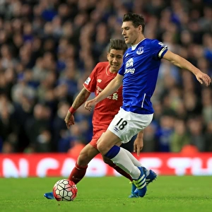 Intense Rivalry: Firmino vs. Barry - Liverpool vs. Everton at Anfield: A Battle for the Ball