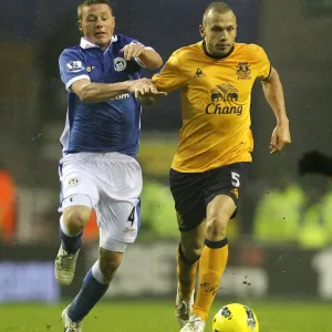 Intense Rivalry: Heitinga vs McCarthy's Battle for Ball Possession - Wigan Athletic vs Everton, Barclays Premier League (04 February 2012) Intense Rivalry: Heitinga vs McCarthy's Battle for Ball Possession - Wigan Athletic vs Everton, Barclays Premier League (04 February 2012)