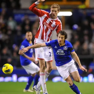 Intense Rivalry: Leighton Baines vs. Peter Crouch's Battle for the Ball at Goodison Park - Everton vs. Stoke City, Barclays Premier League (2011) Intense Rivalry: Leighton Baines vs. Peter Crouch's Battle for the Ball at Goodison Park - Everton vs. Stoke City, Barclays Premier League (2011)