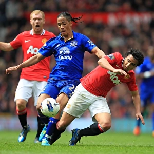 Intense Rivalry: Rafael Da Silva vs. Steven Pienaar - Battle for Ball Possession (Manchester United vs. Everton, Barclays Premier League, Old Trafford, 2012)