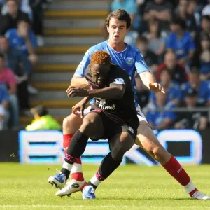 Intense Rivalry: Saha vs. Wilson's Battle for Ball in the Premier League Clash at Fratton Park Intense Rivalry: Saha vs. Wilson's Battle for Ball in the Premier League Clash at Fratton Park