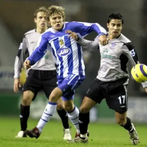 Intense Rivalry: Tim Cahill vs. Jimmy Bullard Clash at Wigan Athletic vs. Everton, FA Barclays Premiership (January 2006) Intense Rivalry: Tim Cahill vs. Jimmy Bullard Clash at Wigan Athletic vs. Everton, FA Barclays Premiership (January 2006)