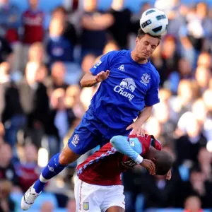 Jagielka's Dominance: Everton's Phil Jagielka Outmuscles Young in Aston Villa vs Everton (Barclays Premier League, 29 August 2010, Villa Park) Jagielka's Dominance: Everton's Phil Jagielka Outmuscles Young in Aston Villa vs Everton (Barclays Premier League, 29 August 2010, Villa Park)