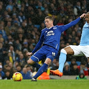 James McCarthy Faces Pressure from Fernando: Everton's Tense Shot in Capital One Cup Semi-Final at Etihad Stadium