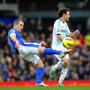 Leon Osman vs Juan Mata: Intense Battle for Ball Possession in Everton vs Chelsea Premier League Clash (December 30, 2012)