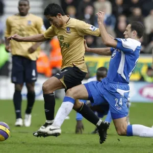 Wigan Athletics Skoko challenges Evertons Cahill for the ball during their English Premier League Wigan Athletics Skoko challenges Evertons Cahill for the ball during their English Premier League