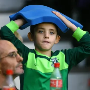 Young Everton Fan's Thrill: Giant Foam Hand at Goodison Park during Everton vs Stoke City (Premier League 2010)