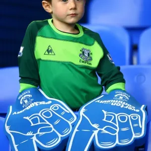 Young Everton Fan's Thrill: Giant Foam Hands at Packed Goodison Park before Everton vs Stoke City (BPL 2010)