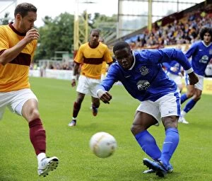 Images Dated 21st July 2012: Anichebe vs. Hateley: A Fiery Clash in Motherwell vs. Everton Pre-Season Friendly at Fir Park