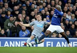 Images Dated 15th March 2015: Arouna Kone vs Ryan Taylor: Intense Clash at Goodison Park - Barclays Premier League