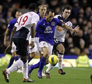 Images Dated 4th January 2012: A Battle for the Ball: Donovan vs. Davies at Goodison Park (Everton vs)