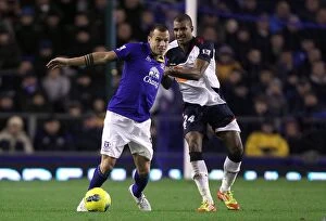 Images Dated 4th January 2012: A Battle for the Ball: Heitinga vs Ngog at Goodison Park - Everton vs Bolton Wanderers