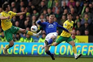 07 April 2012 v Norwich City, Carrow Road Collection: Battle for the Ball: Hibbert vs Howson - Everton vs Norwich City Rivalry in the Premier League