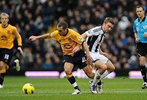 Images Dated 1st January 2012: Battle for the Ball: Morrison vs Osman - Premier League Clash between West Bromwich Albion