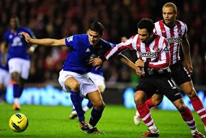 Images Dated 26th December 2011: Battle for the Ball: Tim Cahill vs. Kieran Richardson - Everton vs
