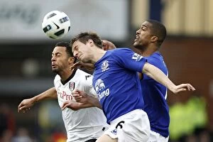 Images Dated 19th March 2011: Battle at Goodison Park: Distin, Jagielka vs Dembele - Everton's Defensive Triumph