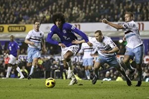 Images Dated 24th January 2011: Battle at Goodison Park: Fellaini's Intense Clash with Upson and Spector