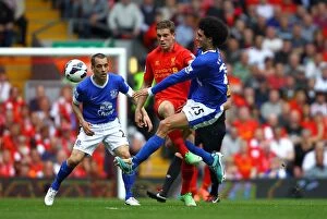 Images Dated 5th May 2013: Battleground Anfield: Henderson vs. Fellaini - Intense Premier League Rivalry (05-05-2013)