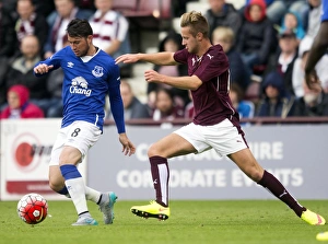 Battling for the Ball: Oviedo vs McGhee - Pre-Season Clash at Tynecastle Stadium