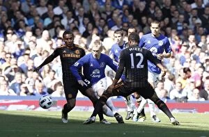 Images Dated 22nd May 2011: Clash at Goodison Park: Hibbert Stands Ground Against Malouda and Mikel