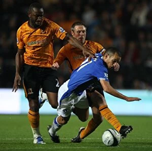 Images Dated 23rd September 2009: Determined Leon Osman's Battle: Everton vs. Hull City in Carling Cup - Overcoming Double Tackle
