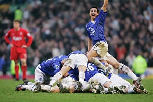 Everton 1 Liverpool 0 Collection: The Everton team pile on Lee Carsley after his goal