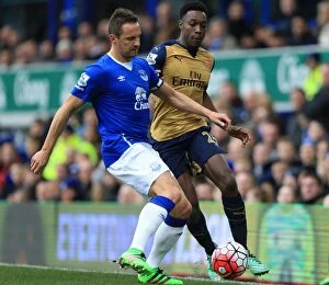 Everton v Arsenal - Goodison Park Collection: Everton vs Arsenal: Jagielka vs Welbeck - A Battle for the Ball in the Barclays Premier League at