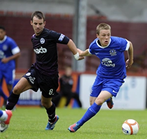 Season 2012-13 Prints: Everton's George Green vs. Partick Thistle's Sean Welsh: A Fierce Pre-Season Rivalry at Firhill Stadium