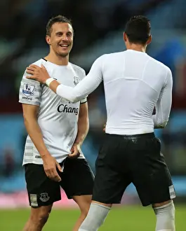 Aston Villa V Everton - Villa Park Prints: Everton's Jagielka and Funes Mori: Victory Celebration vs