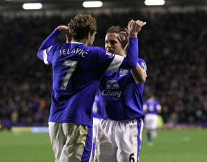 Everton 2 V Tottenham Hotspur 1 : Goodison Park : 09-12-2012 Prints: Everton's Jelavic and Jagielka: A Celebratory Moment as Everton Takes a 2-1 Lead Over Tottenham (December 9)