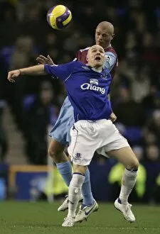 Everton v West Ham United Collection: Evertons Johnson challenges West Ham Uniteds Konchesky for the ball during their English Premier L
