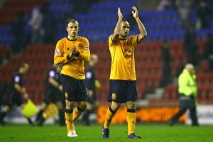 Images Dated 4th February 2012: Everton's Neville and Donovan Celebrate with Fans After Wigan Victory (04 February 2012)