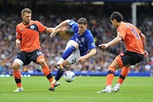 Images Dated 20th August 2011: Everton's Ross Barkley Faces Off Against Faurlin and Buzsaky of QPR in Intense Premier League