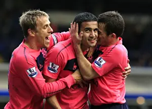 Tim Cahill Prints: Everton's Triumphant Trio: Tim Cahill's Double Celebration with Baines and Neville