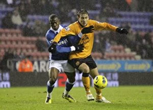 Images Dated 4th February 2012: Figueroa vs. Jelavic: A Battle for Ball Supremacy - Wigan Athletic vs. Everton