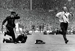 FA Cup Final -1966 Collection: The Great Pitch Invasion: A Fan's Escape at the 1966 FA Cup Final - Everton vs. Sheffield Wednesday