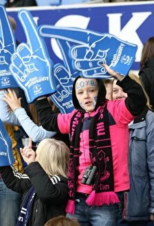 30 October 2010 Everton v Stoke City Collection: Half-Time Thrills: A Young Everton Fan's Excitement with Giant Foam Hands at Goodison Park