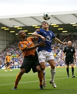 Images Dated 9th December 2010: Intense Battle for Ball Possession: Baines vs. Henry