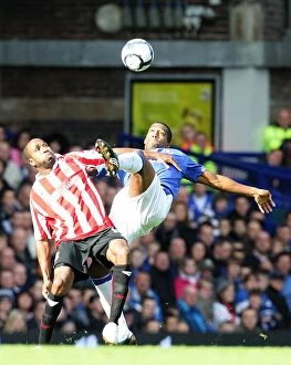 Images Dated 4th October 2009: Intense Battle for Ball Possession: Distin vs. Fuller at Goodison Park - Everton vs