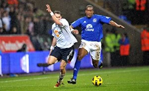 Images Dated 13th February 2011: Intense Battle for Ball Possession: Distin vs Elmander, Everton vs Bolton Wanderers