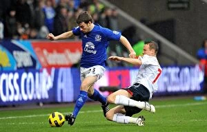 Images Dated 13th February 2011: Intense Battle for Ball Possession: Seamus Coleman vs. Matthew Taylor, Everton vs